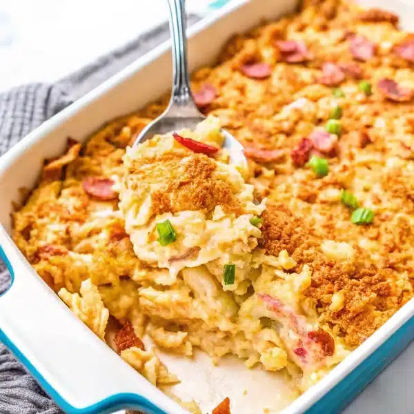 Neiman Marcus Chicken Casserole topped with golden Ritz cracker crumbs and garnished with green onions